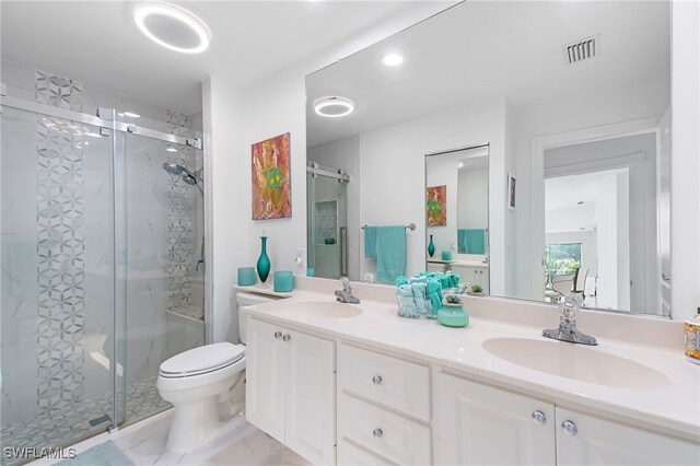 bathroom with vanity, toilet, and a shower with shower door