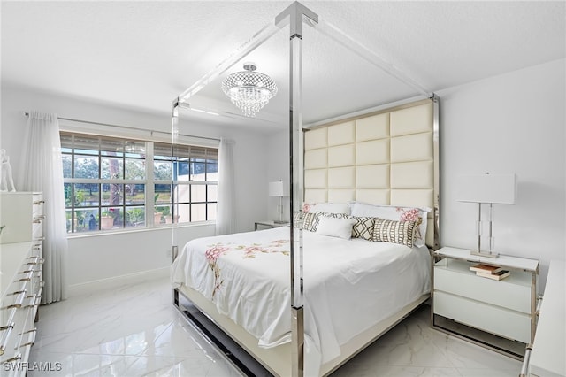 bedroom with a notable chandelier