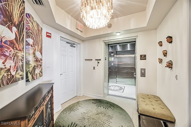 interior space with light tile patterned floors and an inviting chandelier