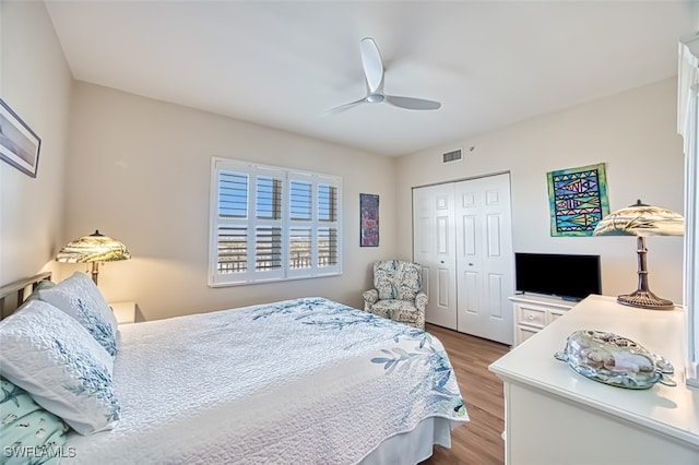 bedroom featuring ceiling fan, a closet, and light hardwood / wood-style floors