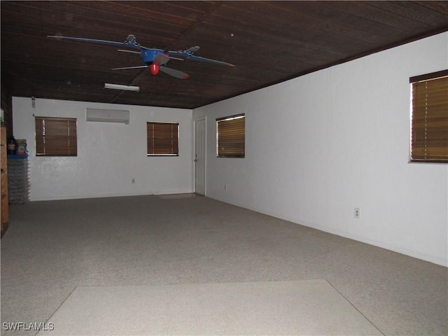 spare room featuring a wall unit AC, ceiling fan, and wooden ceiling