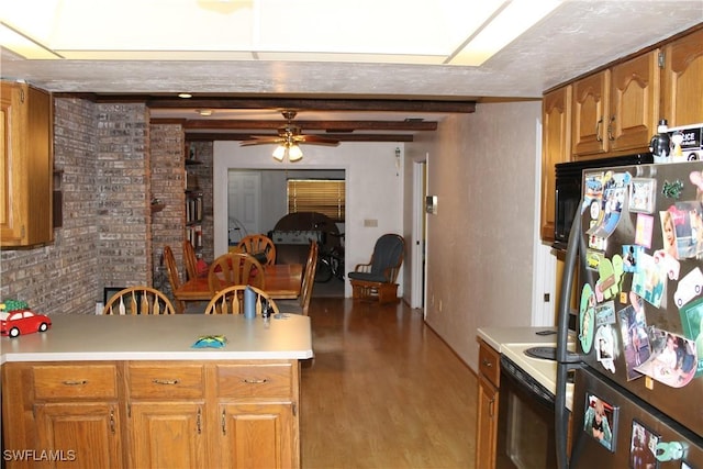 kitchen with electric stove, ceiling fan, fridge, beam ceiling, and brick wall