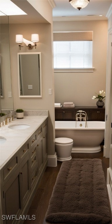 bathroom with a bathing tub, plenty of natural light, vanity, and hardwood / wood-style flooring