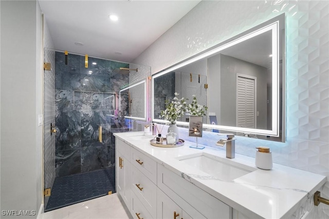 bathroom featuring double vanity, a shower stall, and a sink