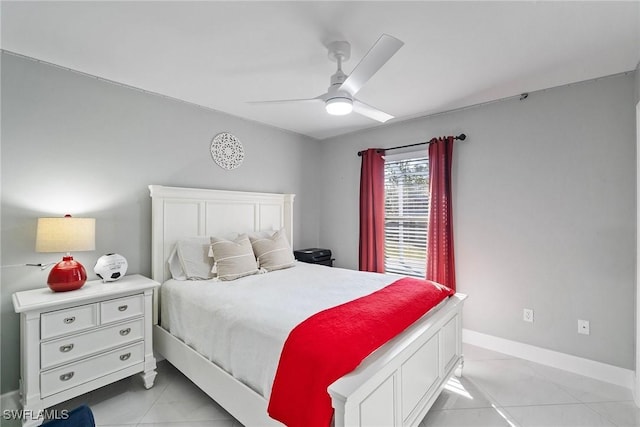 bedroom with light tile patterned floors, a ceiling fan, and baseboards