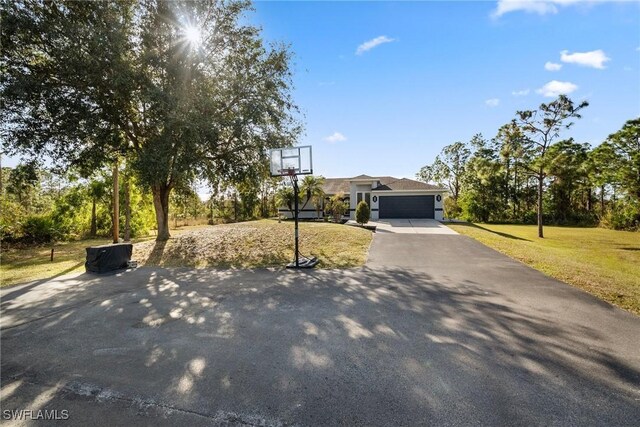 view of front of house with a garage and a front lawn