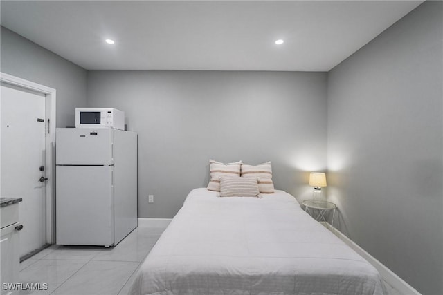 bedroom featuring white refrigerator