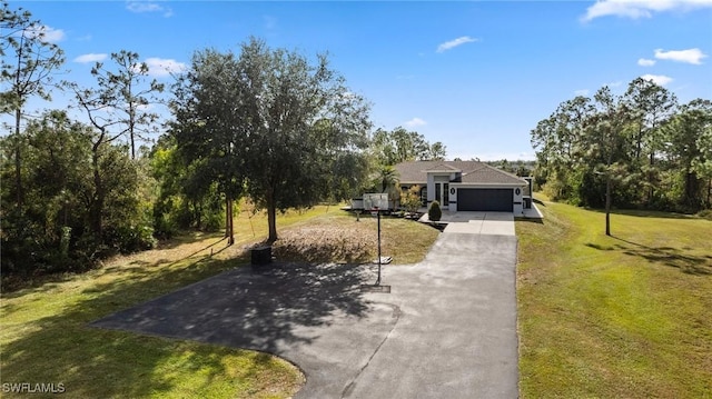 view of front of home with a garage and a front lawn