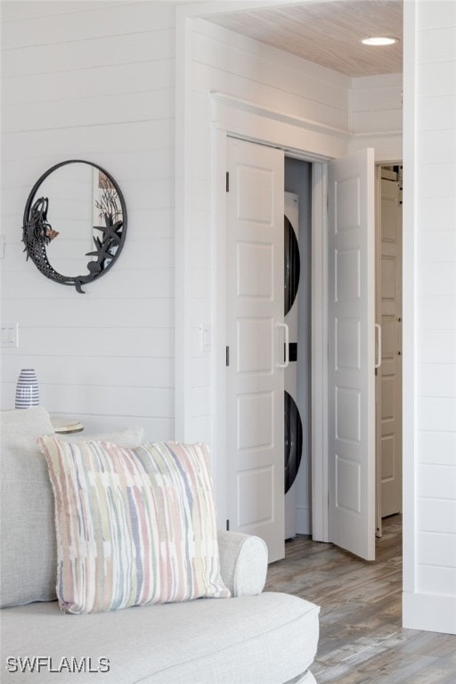 bedroom featuring wood ceiling, wooden walls, and light hardwood / wood-style flooring