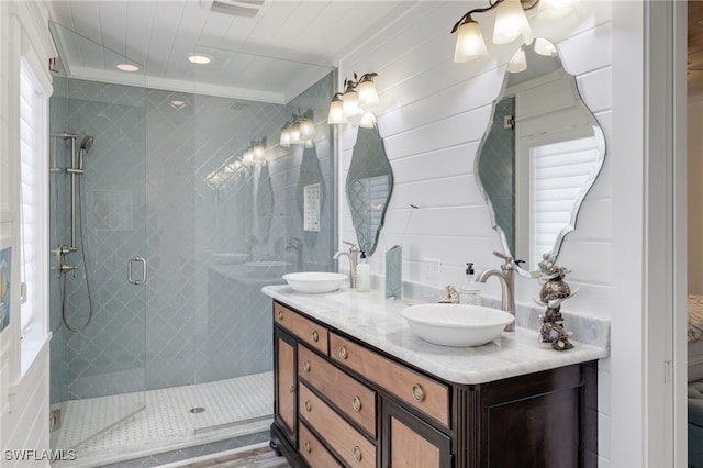 bathroom featuring plenty of natural light, vanity, and an enclosed shower