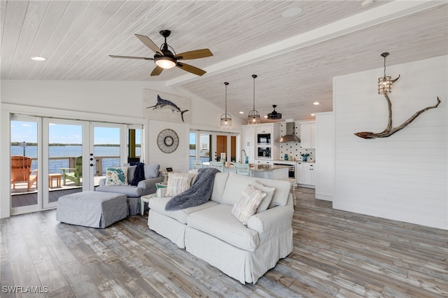 living room featuring a water view, light wood-type flooring, wood ceiling, and french doors