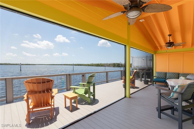 deck with an outdoor living space and a water view