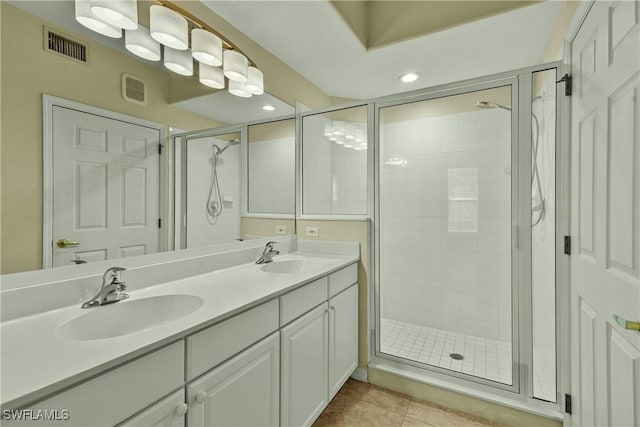 bathroom featuring tile patterned flooring, vanity, and a shower with shower door