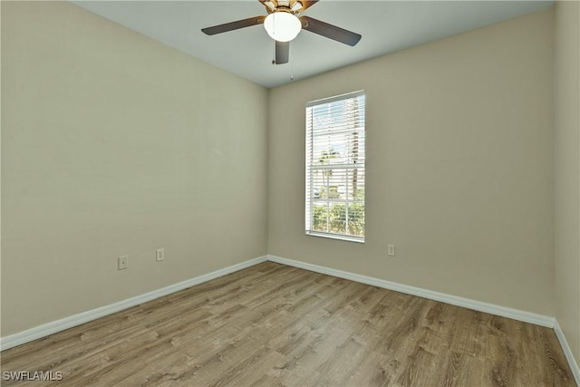 empty room featuring ceiling fan and light wood-type flooring