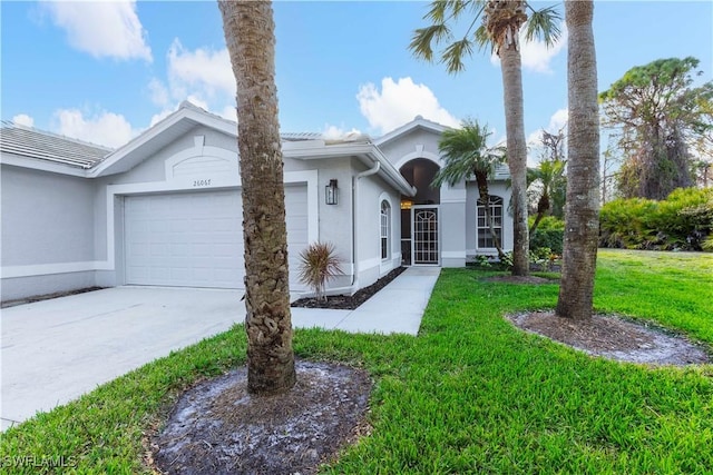 ranch-style house featuring a front lawn and a garage