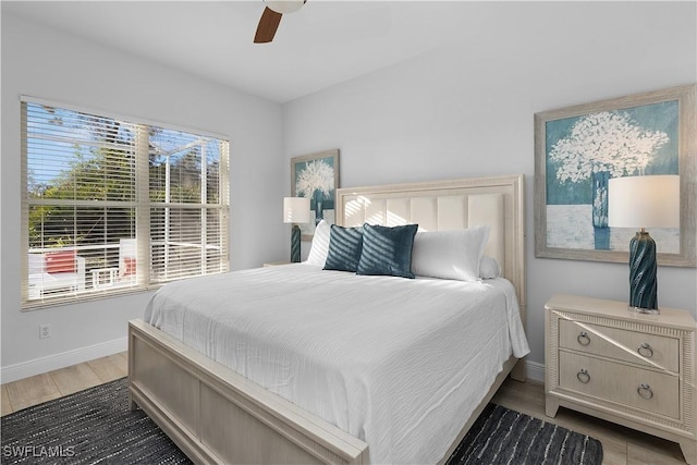 bedroom with ceiling fan and dark hardwood / wood-style floors