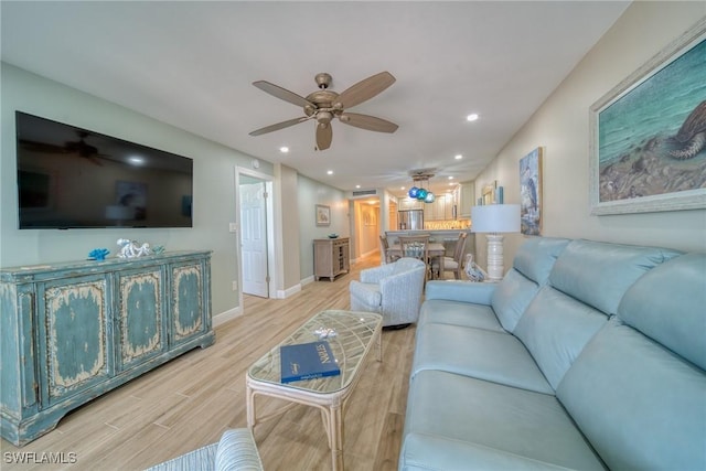 living room with ceiling fan and light wood-type flooring