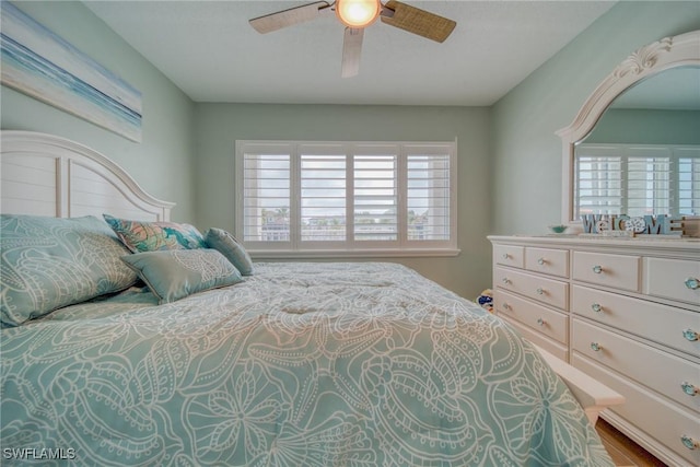 bedroom with ceiling fan and hardwood / wood-style floors