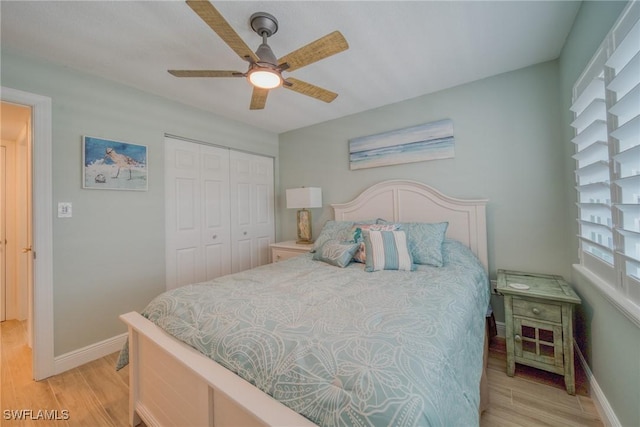 bedroom featuring ceiling fan, a closet, and light wood-type flooring