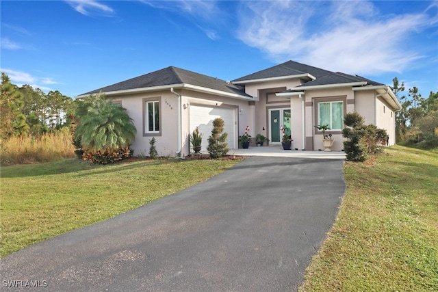 view of front of home with a garage and a front yard