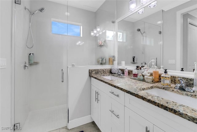 bathroom with a shower with door and vanity