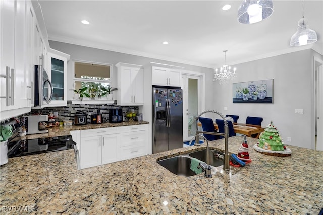 kitchen featuring pendant lighting, backsplash, stainless steel appliances, and stone counters