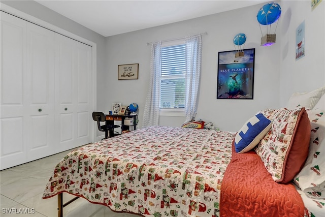 bedroom featuring tile patterned flooring and a closet