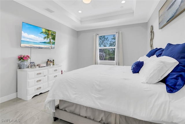 bedroom featuring a raised ceiling and ceiling fan