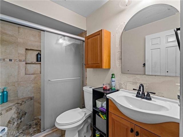 bathroom with tasteful backsplash, a shower with door, vanity, and toilet