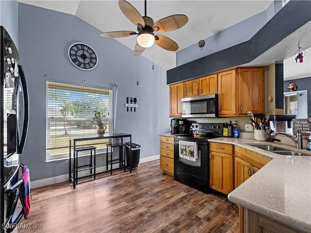 kitchen featuring dark hardwood / wood-style flooring, ceiling fan, sink, black appliances, and high vaulted ceiling