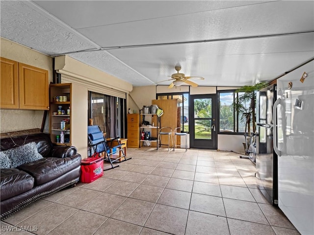 living room with ceiling fan and light tile patterned floors