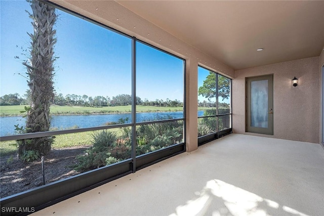 unfurnished sunroom with a water view