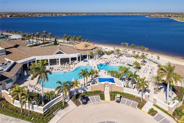 drone / aerial view featuring a water view and a beach view