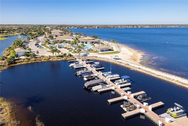 drone / aerial view featuring a water view and a beach view