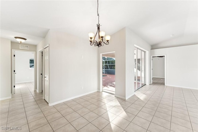 spare room with light tile patterned floors, lofted ceiling, and a notable chandelier