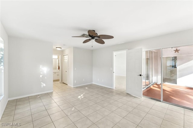 unfurnished room with ceiling fan and light tile patterned floors