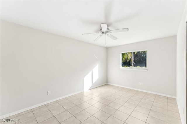 tiled spare room featuring ceiling fan