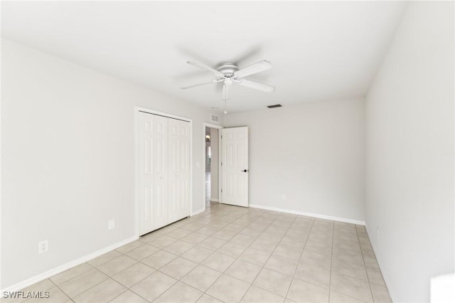 tiled spare room with ceiling fan