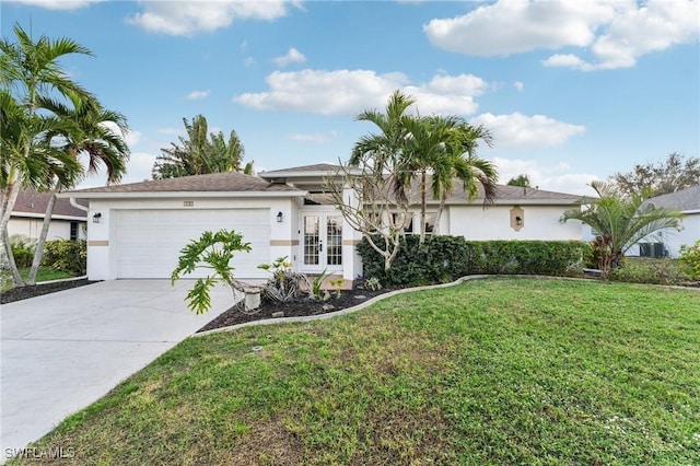 single story home featuring french doors, a front yard, and a garage