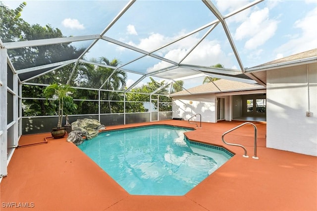 view of swimming pool with a lanai and a patio