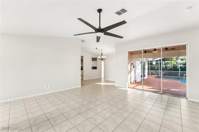 spare room featuring ceiling fan with notable chandelier, lofted ceiling, and light tile patterned floors