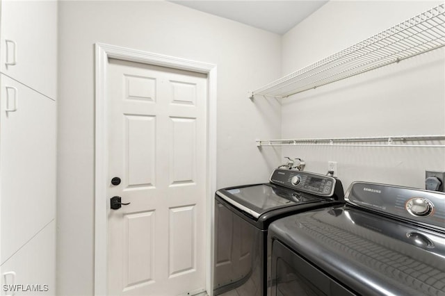 clothes washing area featuring washer and dryer