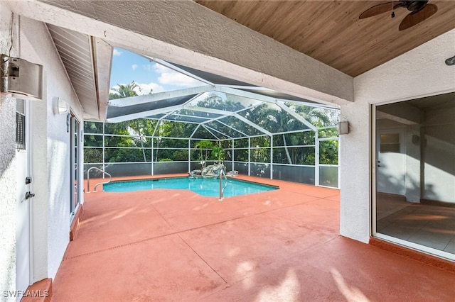 view of swimming pool featuring ceiling fan, a lanai, and a patio