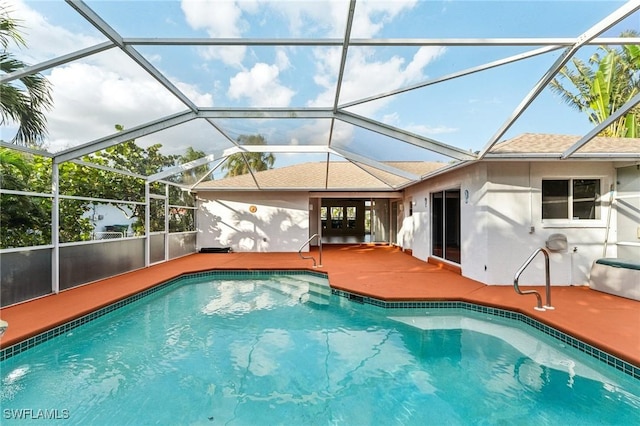 view of pool with a lanai and a patio