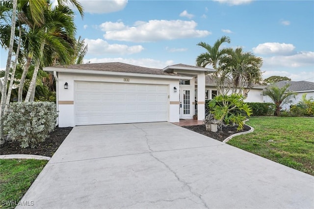 view of front of property with a garage and a front lawn