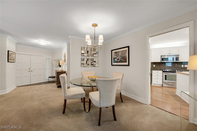 dining room featuring crown molding, light colored carpet, and a notable chandelier