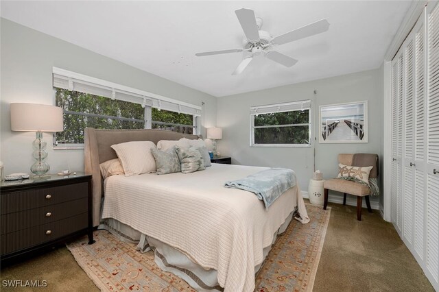 carpeted bedroom featuring ceiling fan and a closet