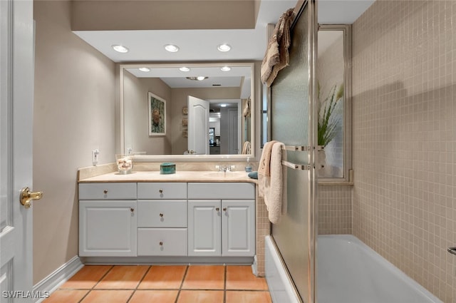 bathroom with tile patterned flooring, vanity, and shower / bath combination with glass door