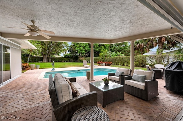 view of swimming pool featuring ceiling fan, a patio, and an outdoor hangout area