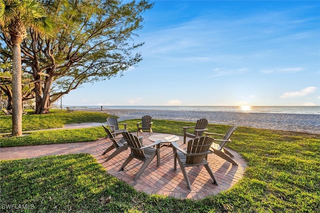 view of patio / terrace with a water view and a view of the beach